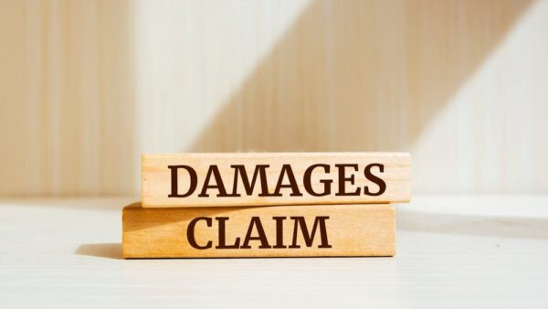 Damages & Claim written on wooden blocks