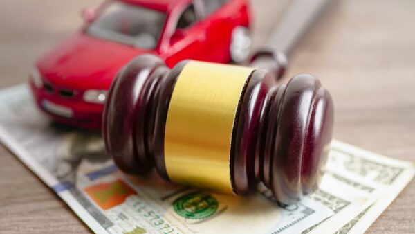 Gavel for judge lawyer with car on US dollar money banknotes.