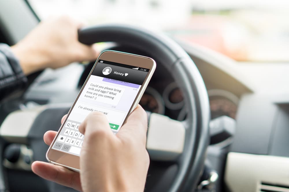 A man texting while driving car