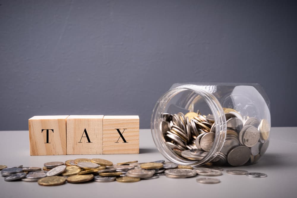 TAX wordings with jar full of coins