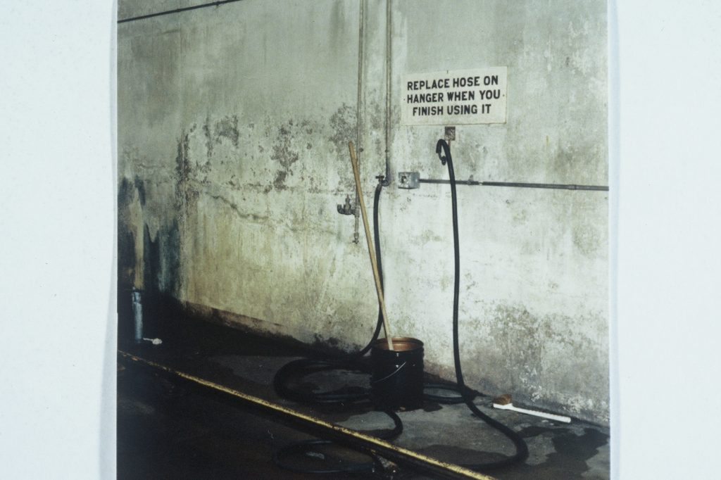 A high-pressure water hose, likely used by firefighters during the Rushin incident, depicted in a photograph illustrating emergency response efforts