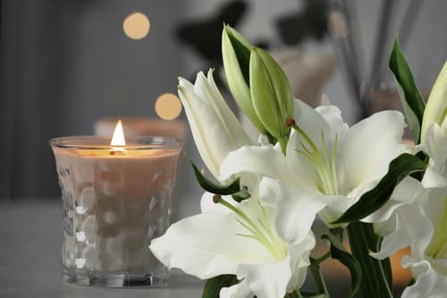 candle and flowers at funeral