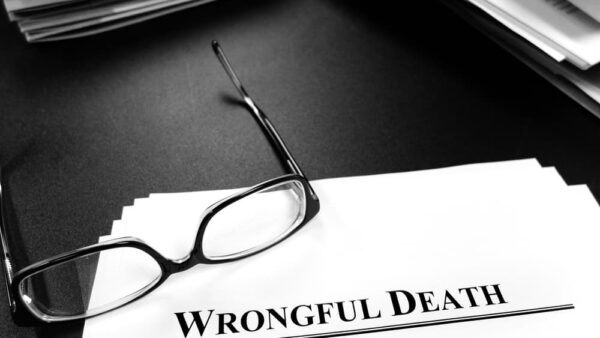 wrongful death paper on desk with glasses