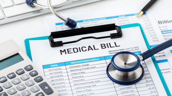 Medical bill and calculator showing costs affecting personal injury settlement