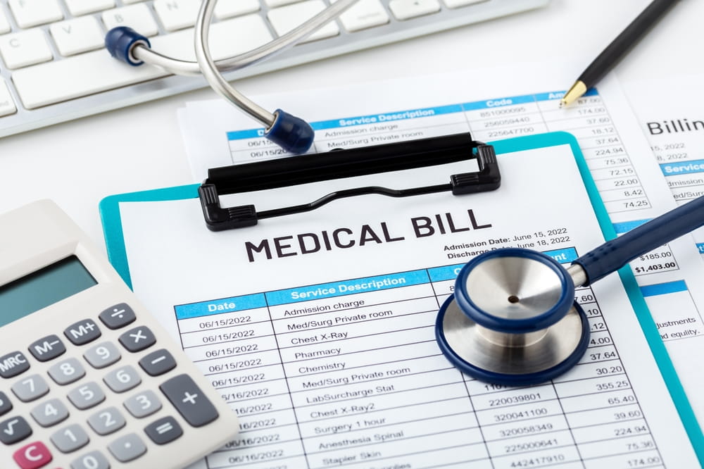 Medical bill and calculator showing costs affecting personal injury settlement