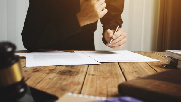 Client signing personal injury settlement agreement with attorney present