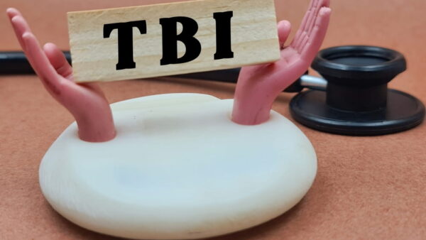 Hands holding TBI block symbolizing legal support in a brain injury claim