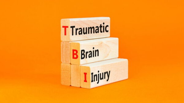 Wooden blocks spelling TBI for traumatic brain injury legal claim concept