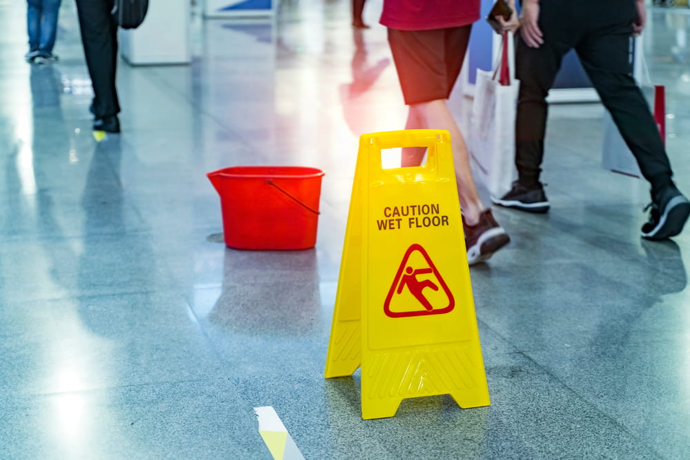 Wet floor warning sign showing slip and fall hazard evidence at accident scene
